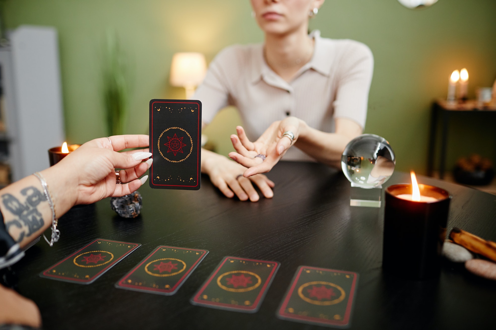 Fortune Teller Holding Tarot Card at Seance