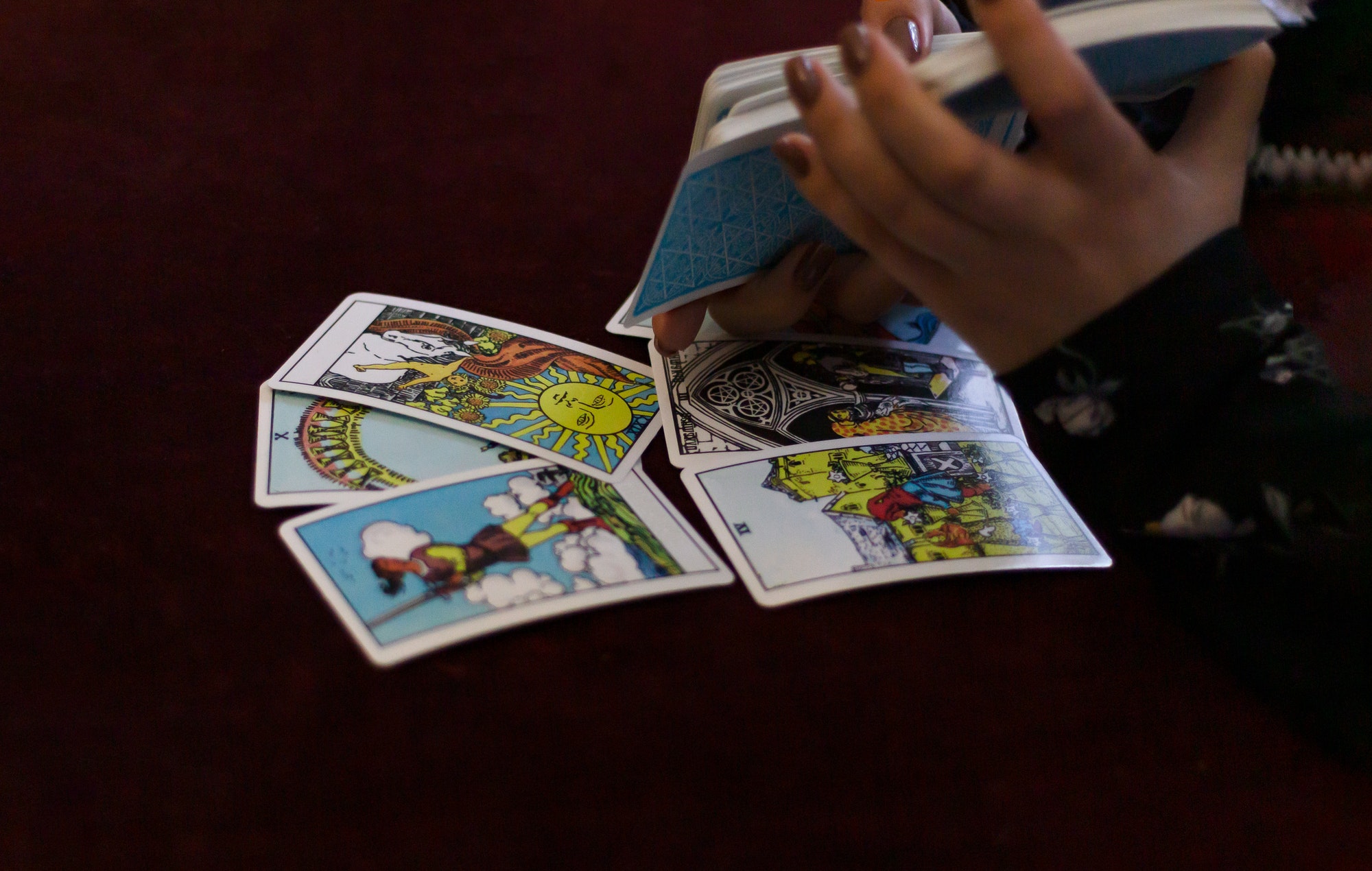 On Walpurgis Night, a fortuneteller lays out tarot cards for a girl.