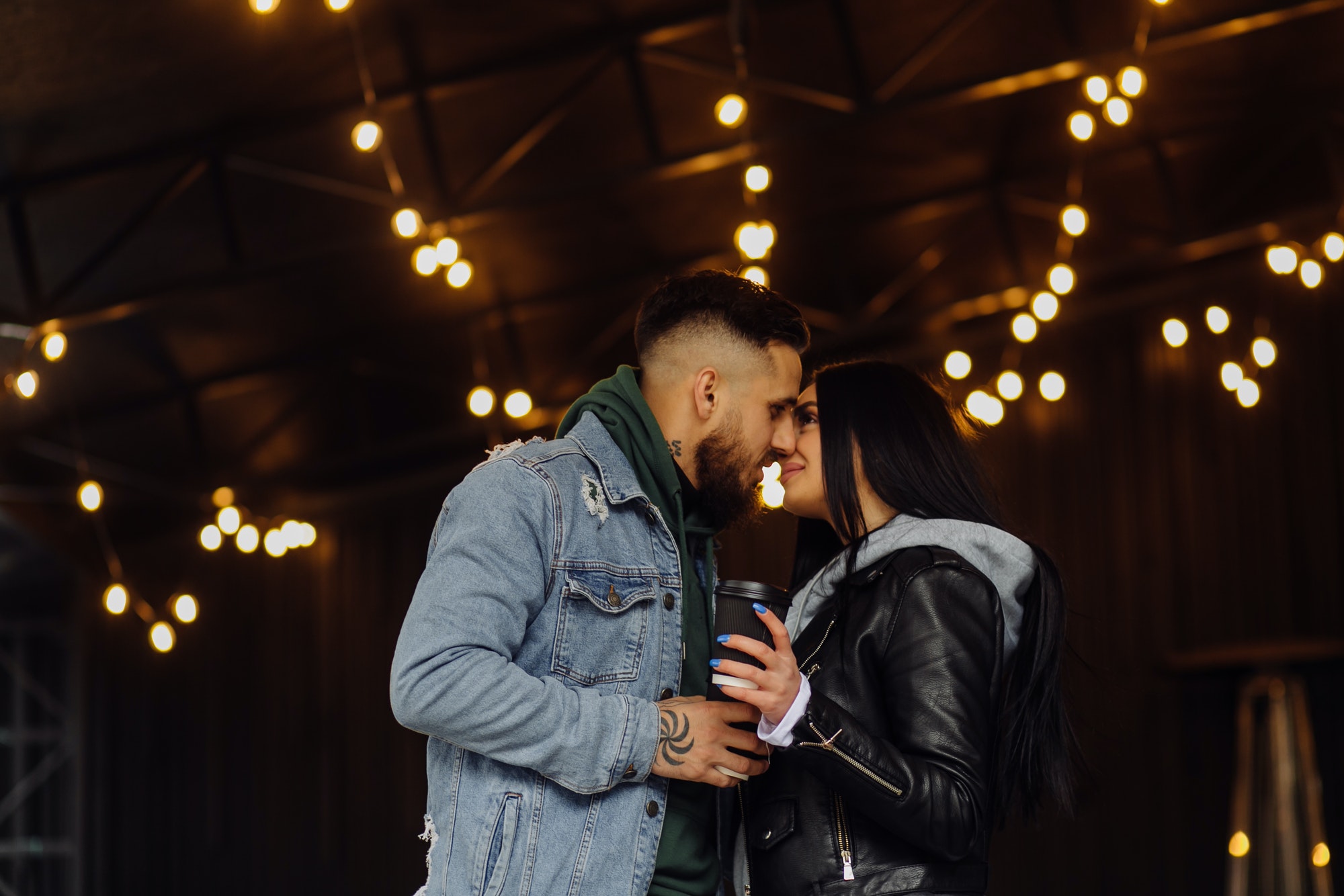 Outdoor happy couple in love posing near cafe